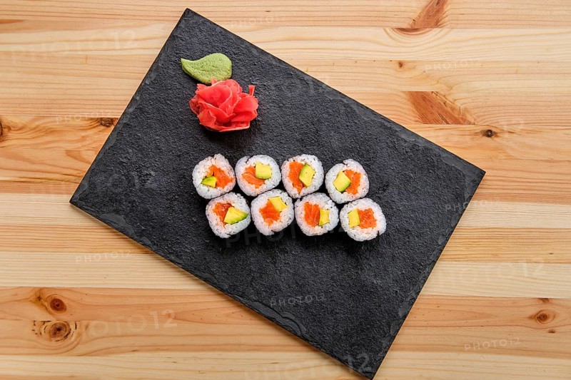 Rolls with salmon and avocado on slate plate