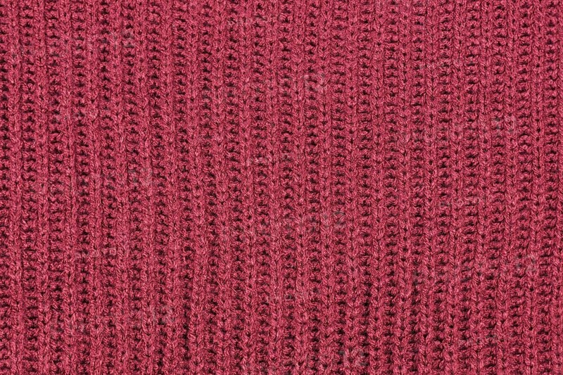 Close up of knitted pattern on blue wool pullover