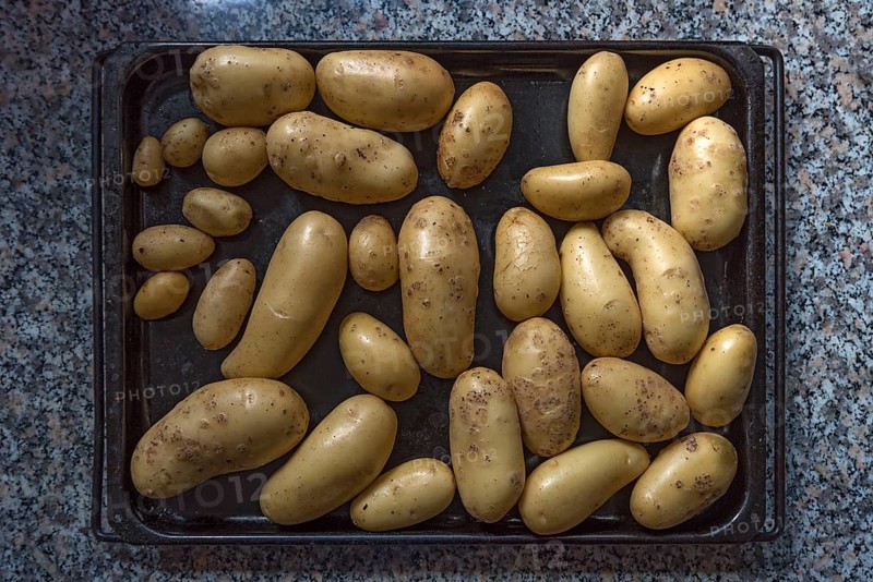 Raw potatoes on a baking tray