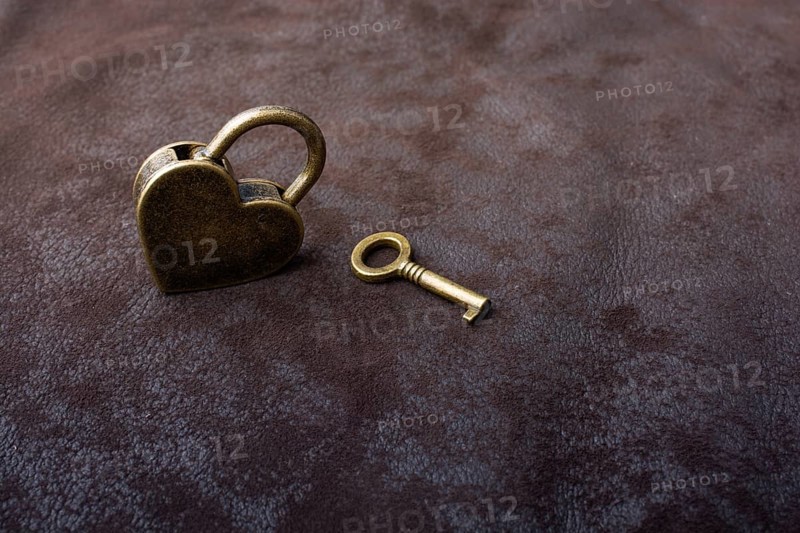 Metal padlock in heart shape as symbol of love