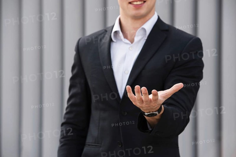 Front view businessman holding hand out