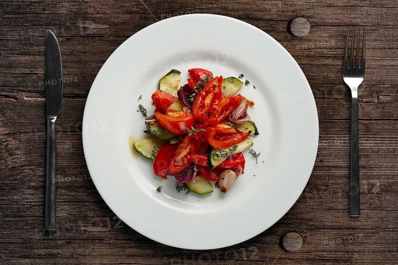 Grilled vegetables on white plate cutted on slices