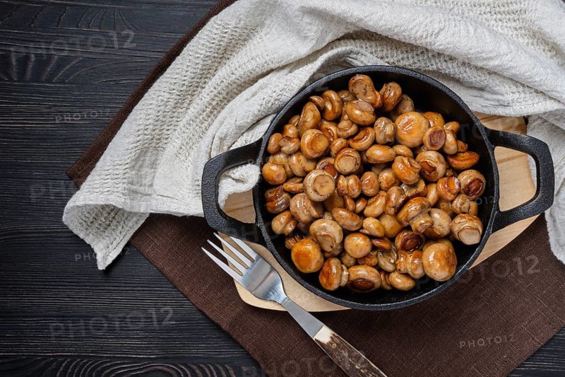 Top view of fried champignon in cast iron skillet