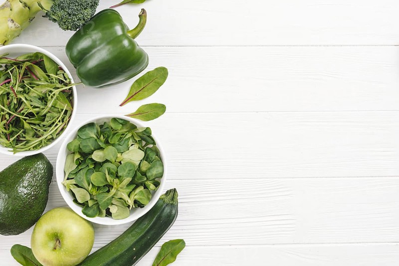 Overhead view green healthy fresh vegetables white wooden desk
