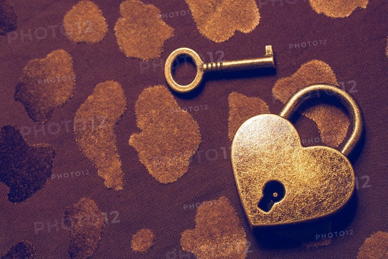 Heart shaped lock and key on an abstract background