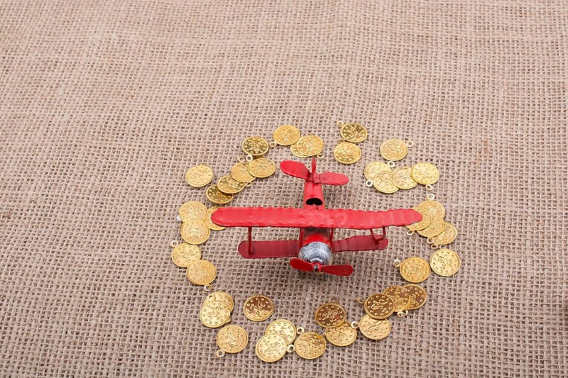Fake gold coins around the retro model airplane
