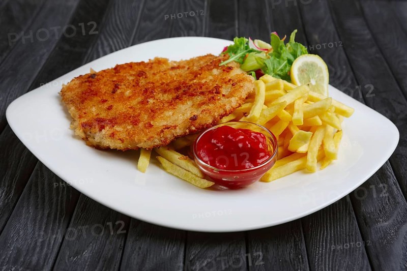Fried chopped pork cutlet with potato balls and creamy sauce with mushroom and onion