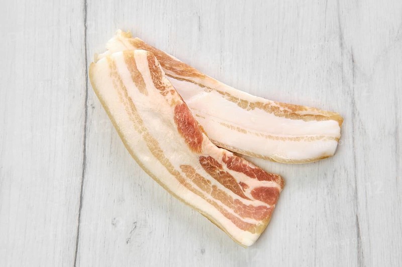 Top view of two slices of bacon on the table