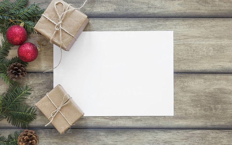 Paper near present boxes and fir branch