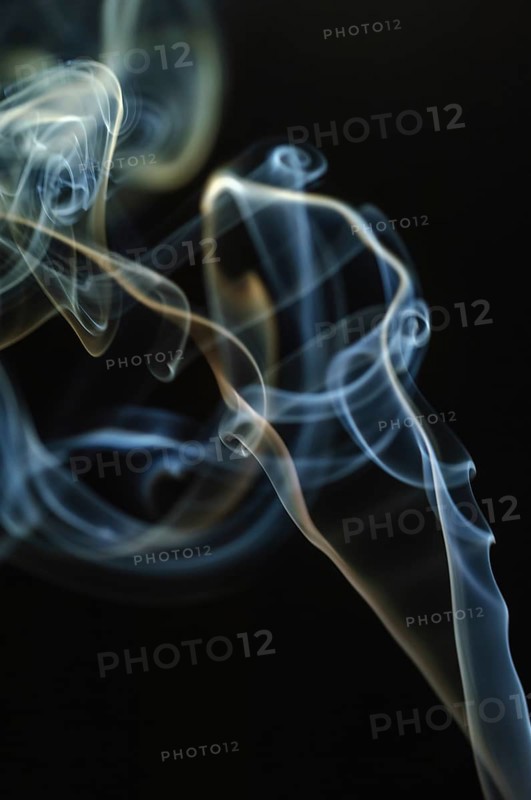 Trajectory of incense smoke in the air showing different shapes. France