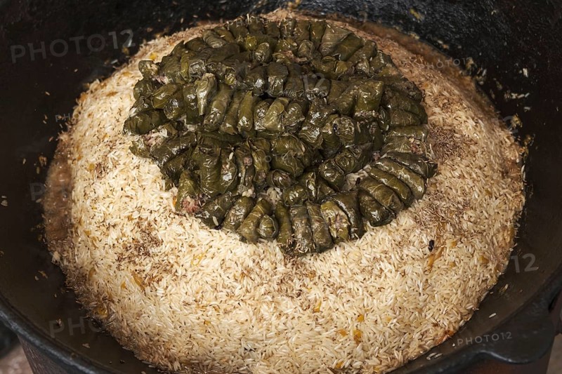 Meat and dolma in cauldron. The making of pilaf