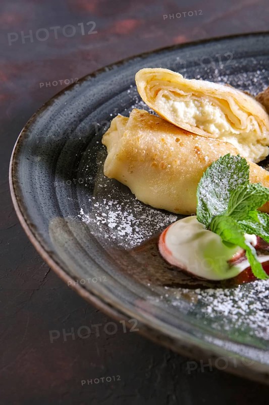 Thin pancakes with curd and sour cream