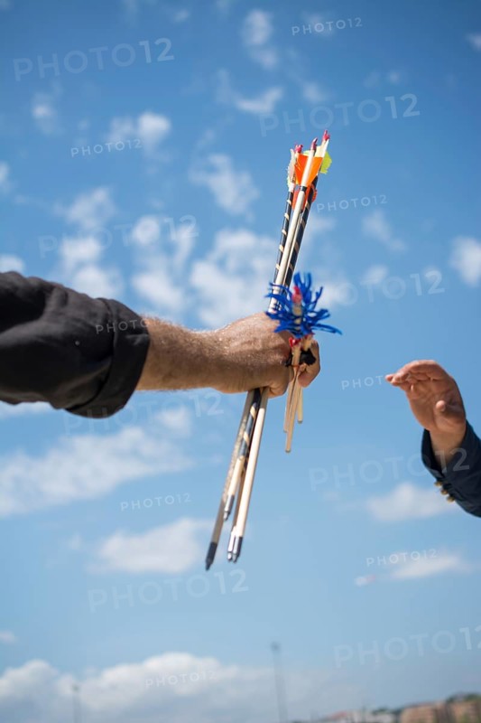 Hand holding old style wooden arrows