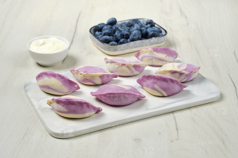 Frozen pierogi with blueberry and sour cream
