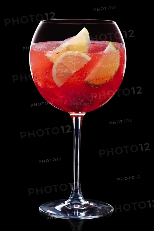 Cold sangria in a wine glass isolated on black