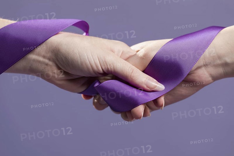 Women hands holding purple satin ribbon. Resolution and high quality beautiful photo