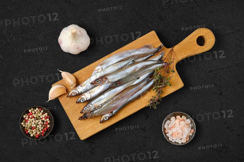 Top view of pile of fresh raw frozen capelin