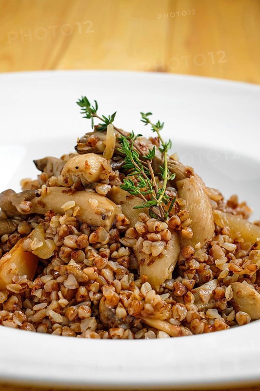 Close up view of boiled buckwheat with marinated mushrooms