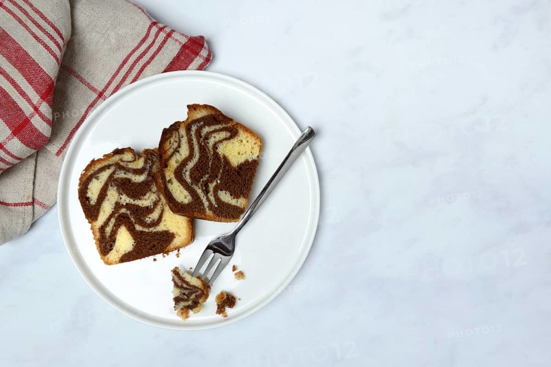Two pieces of marble cake on plate