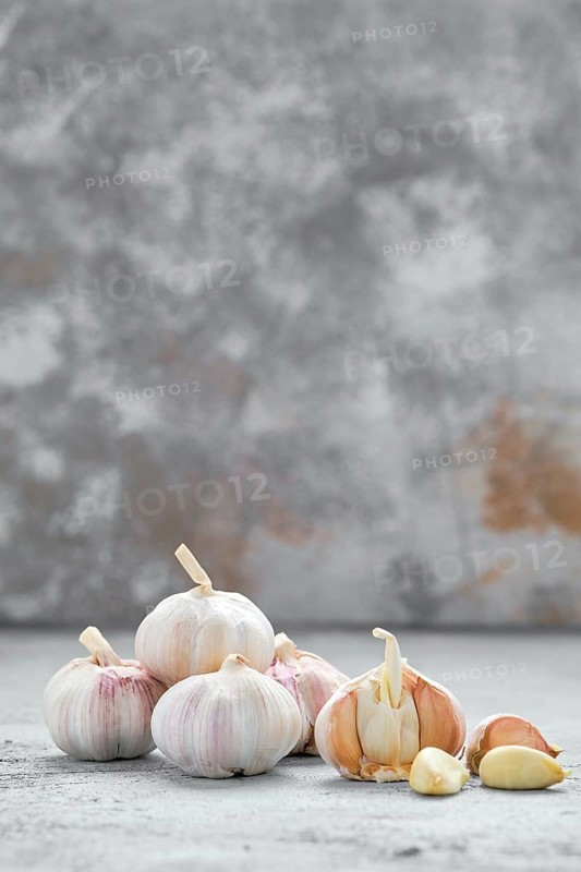 Garlic cloves and bulbs on wooden cutting board