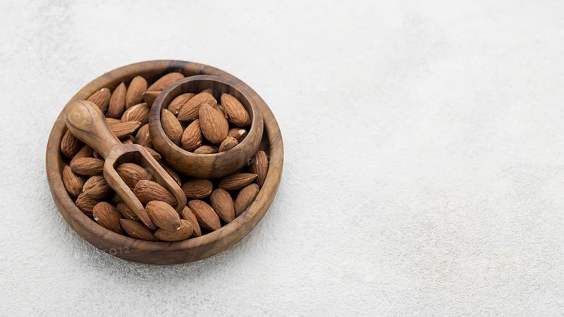 Organic almond nuts bowl copy space