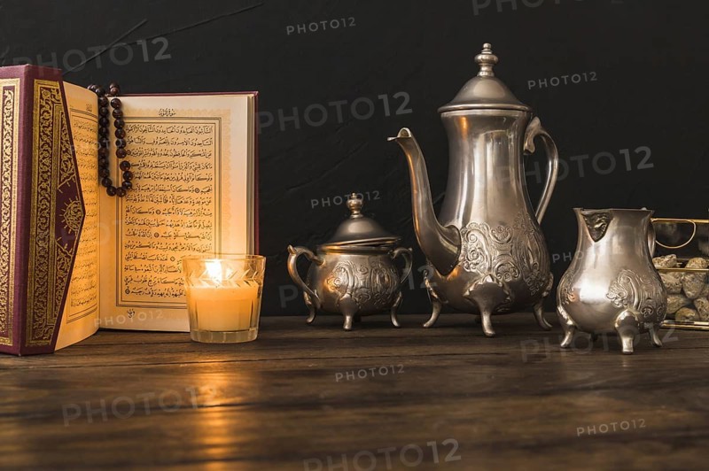 Quran candle near tea set