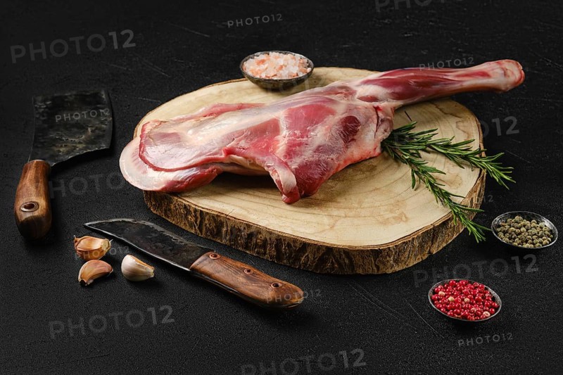 Raw fresh lamb shoulder on black background