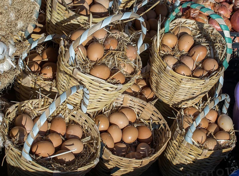 Organic fresh farm eggs in the straw basket
