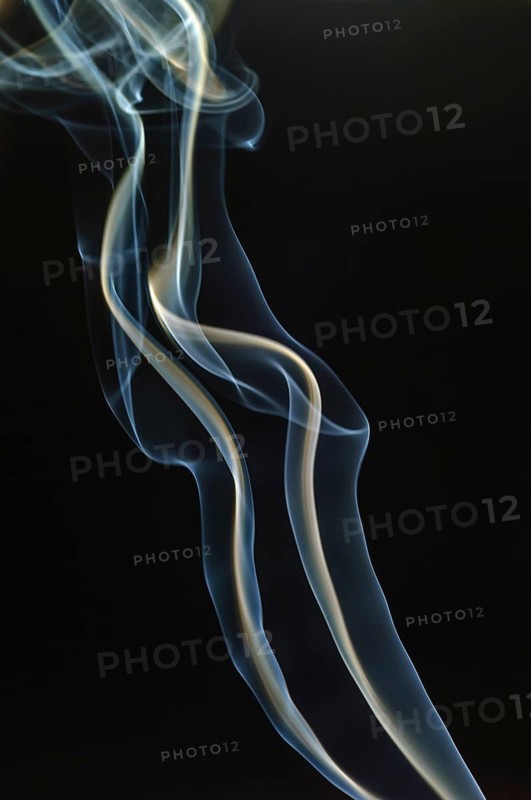 Trajectory of incense smoke in the air showing different shapes. France