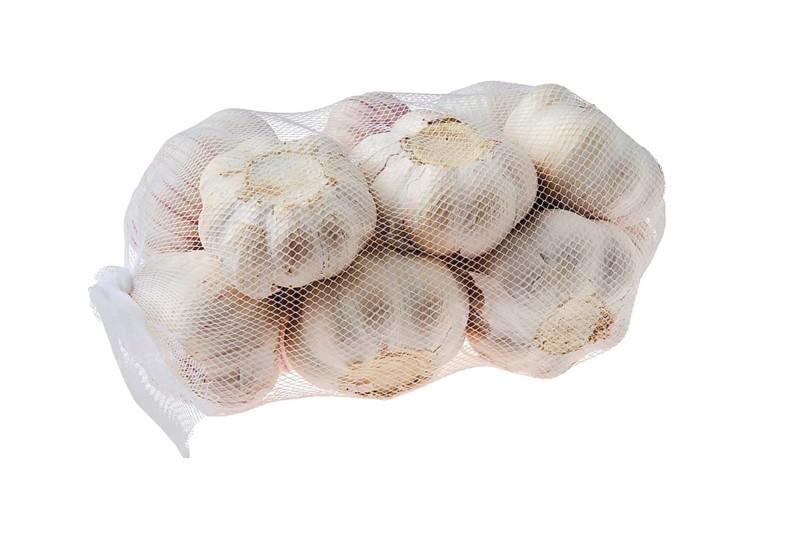 Pouch with garlic bulbs isolated on white