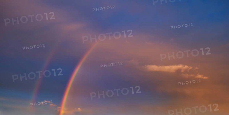 Double rainbow in an atmospheric sky with few cirrocumulus