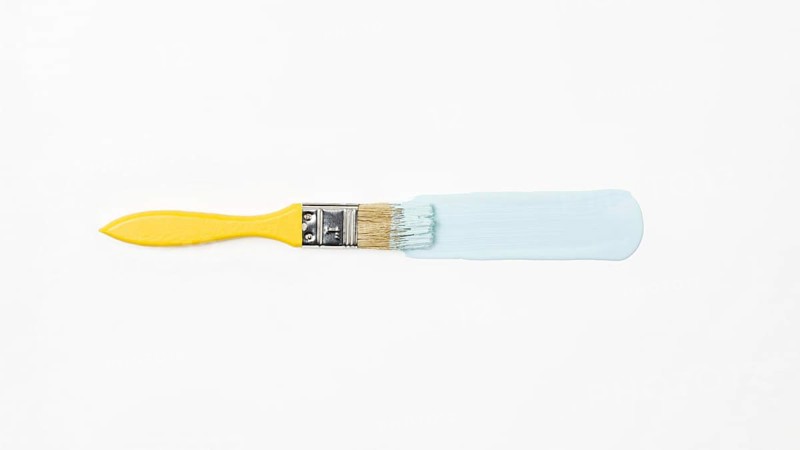 Top view yellow brush with blue paint. Resolution and high quality beautiful photo
