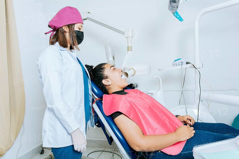 Intraoral radiography concept. Dentist doing intraoral dental x-ray to patient