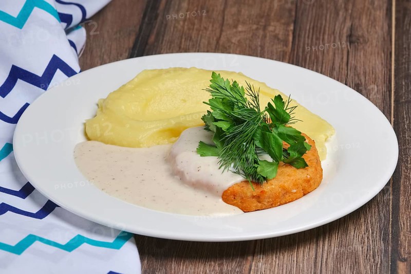 Salmon cutlet and mashed potato with creamy sauce