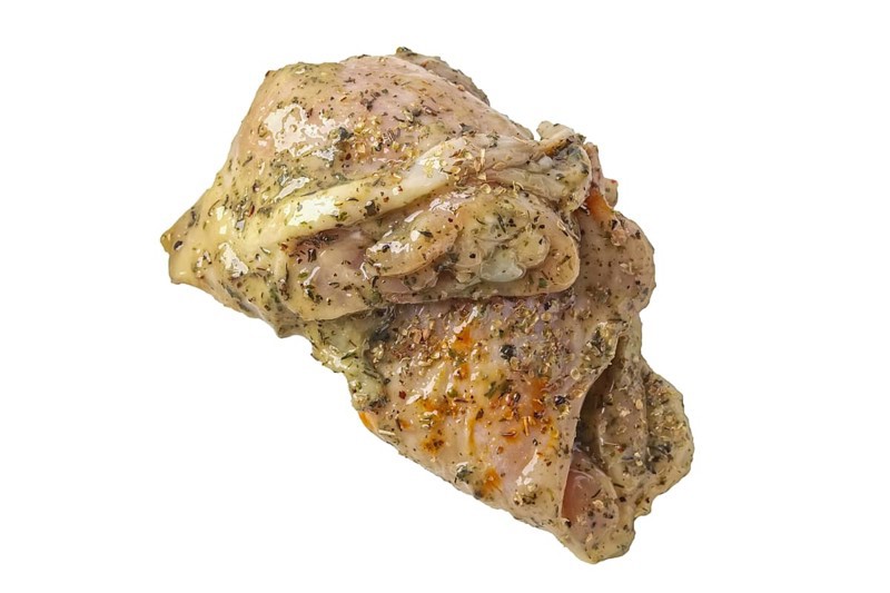 Raw piece of chicken with spice and sauce prepered for barbecue. Gastronomy template isolated on white background