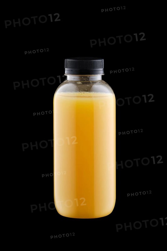 Plastic bottle with orange juice isolated on black