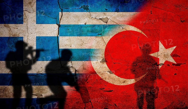 Greece vs. Turkey flag on cracked wall. Concept of war between Turkey and Greece