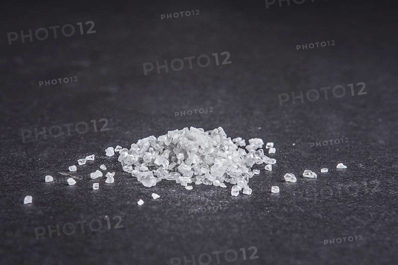 Sea salt on dark background. Side low point of view