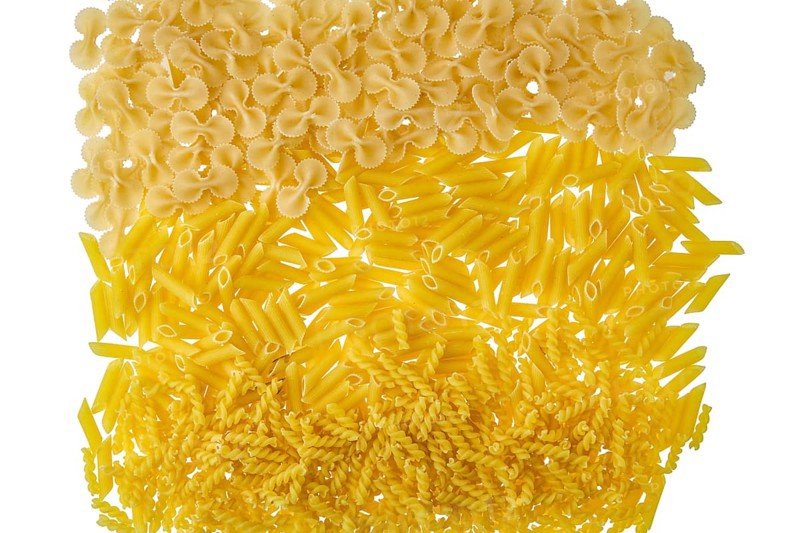 Overhead view of various kinds of pasta isolated on white background