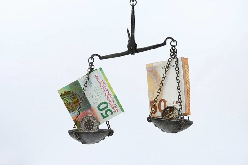 Weighing pan with franc and euro notes