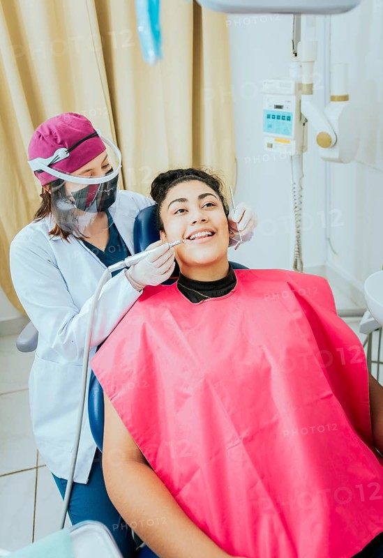 Stomatologist cleaning a patient teeth