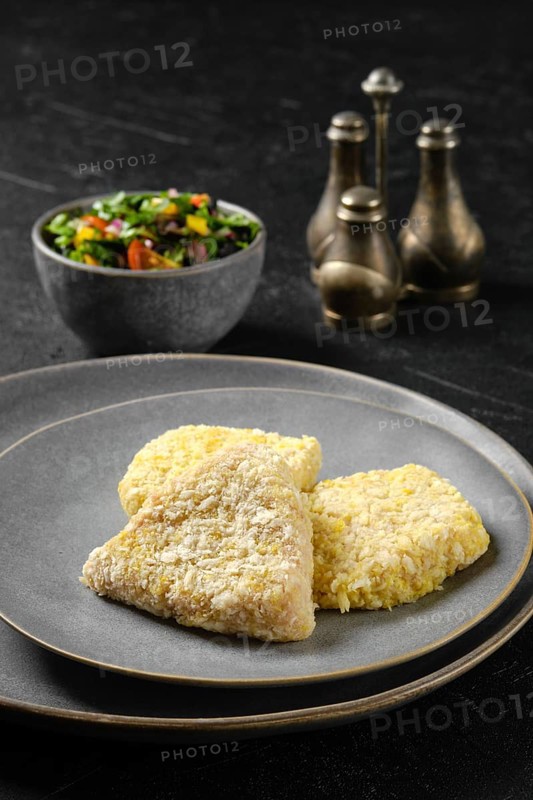 Semifinished squid cutlet in breading on a plate
