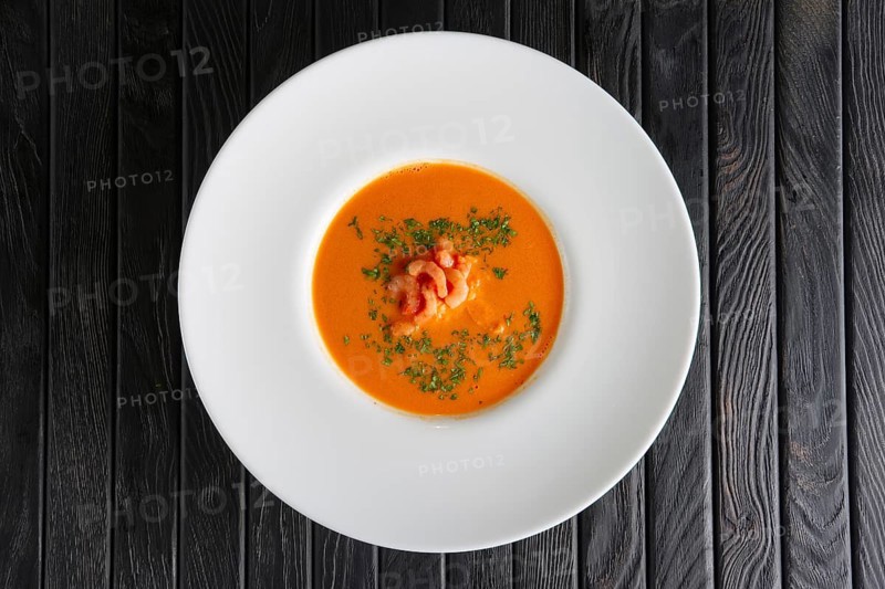 Top view of plate of soup with shrimps