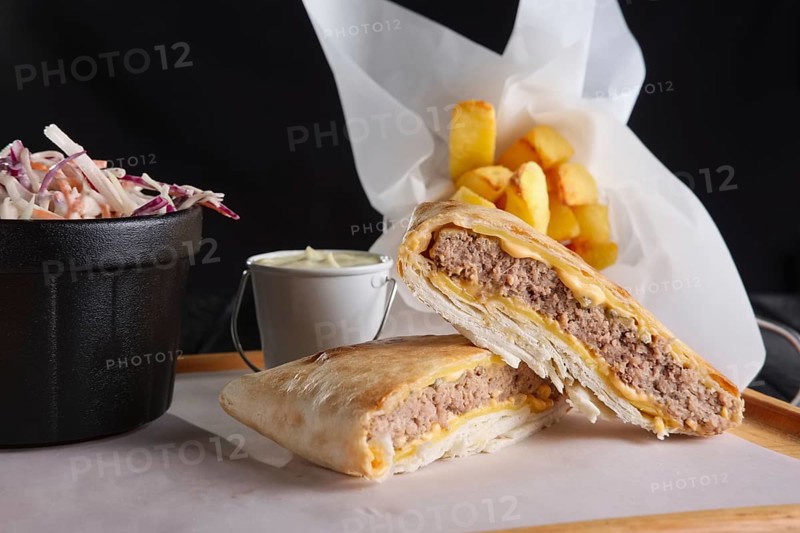 Beef cutlet with cheese rolled in pita with fried potato and red cabbage