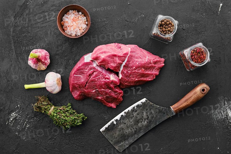 Raw fresh beef chuck eye roast on black background