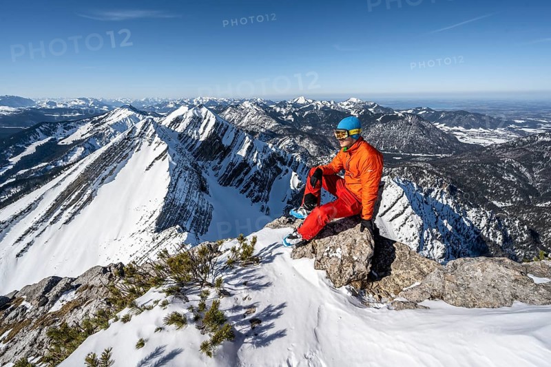 Ski tourer sitting on a rock