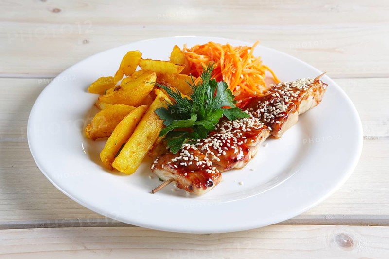 Chicken shashlik with fried potato and spicy carrit