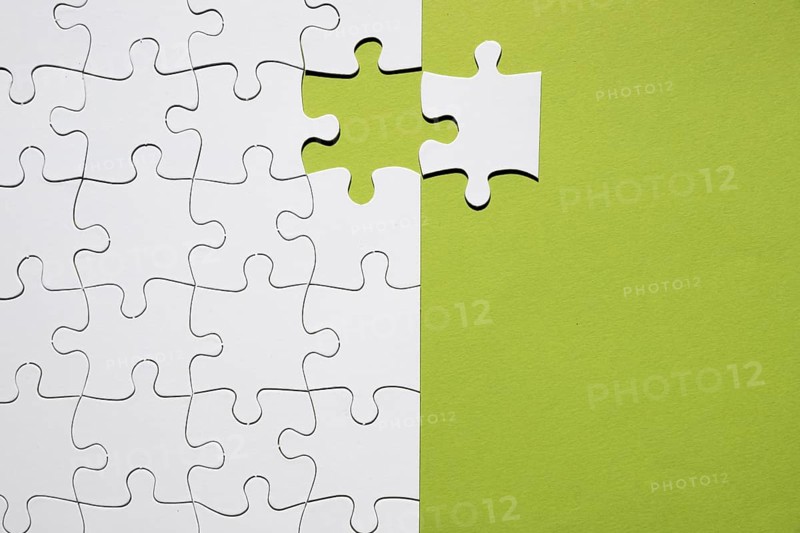 White puzzle piece separate with white puzzle grid green backdrop. Resolution and high quality beautiful photo