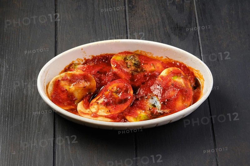 Lamb dumplings with spicy tomato sauce baked in oven