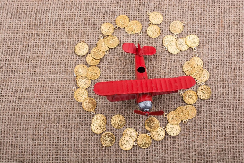 Fake gold coins around the retro model airplane